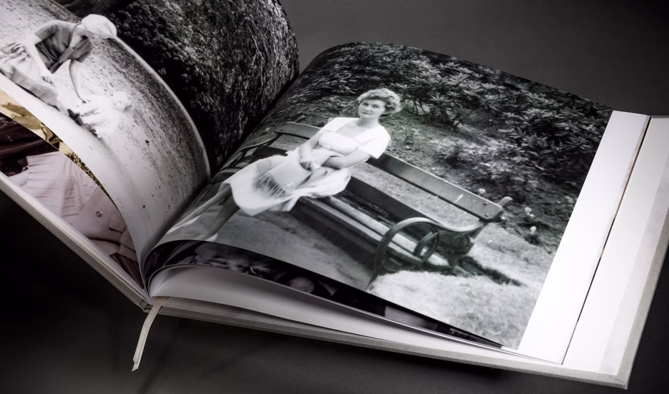 Family history book opened to an archival photograph