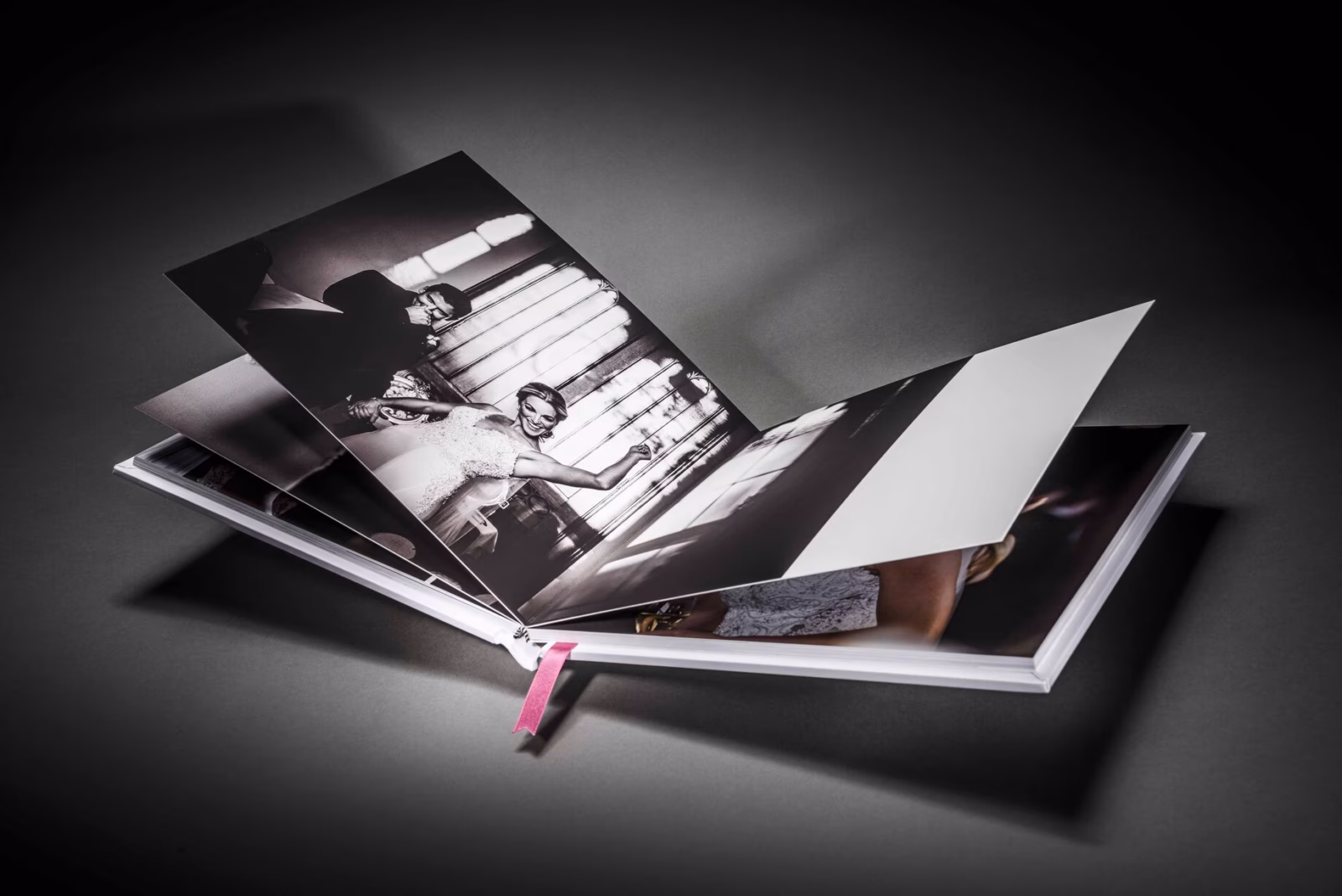 Wedding album opened to a black-and-white reception photograph