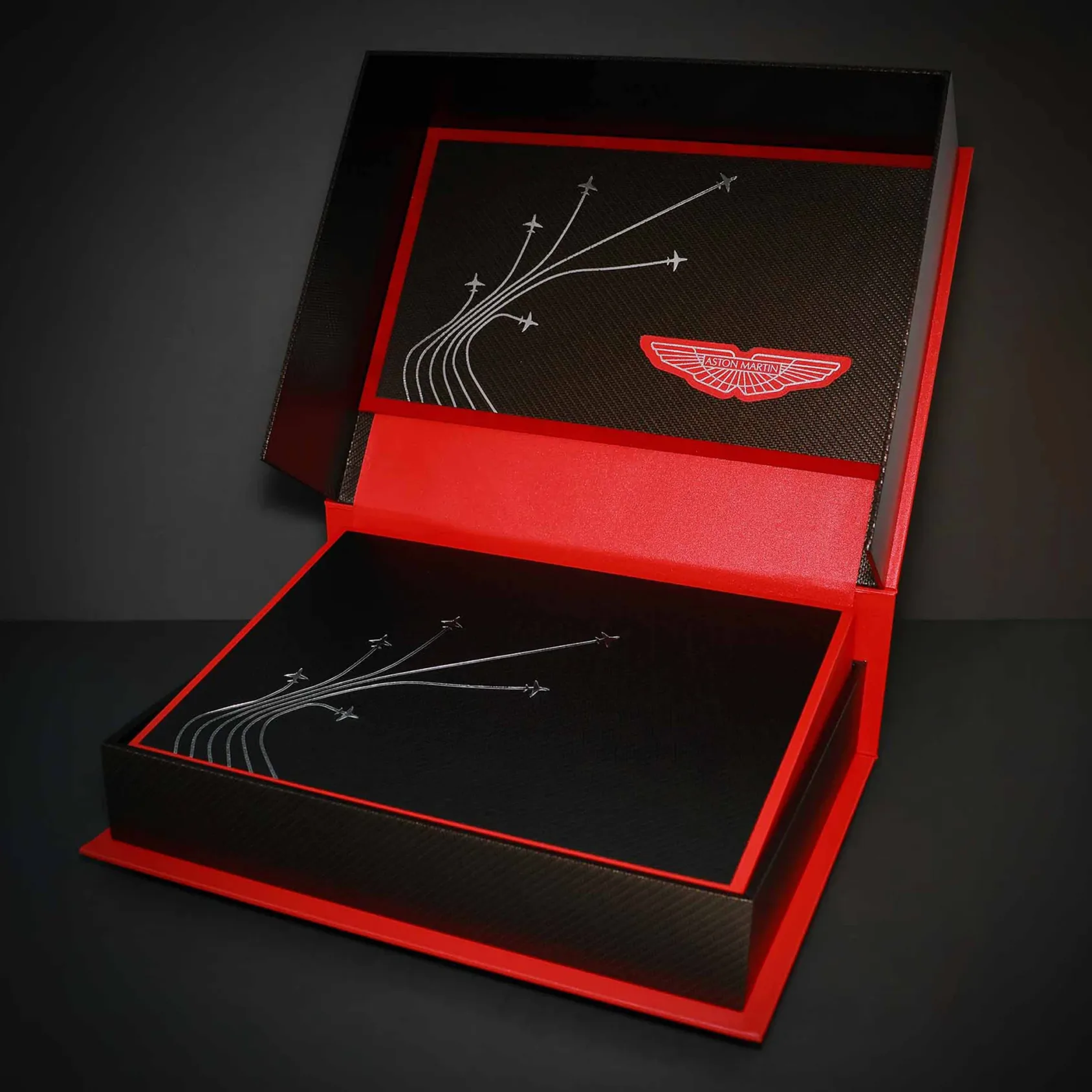 Aston Martin mark on a black and red presentation set