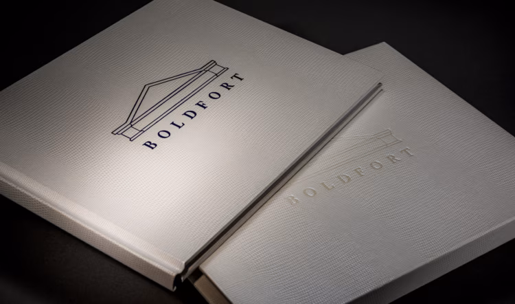 A corporate presentation book opened to an editorial spread