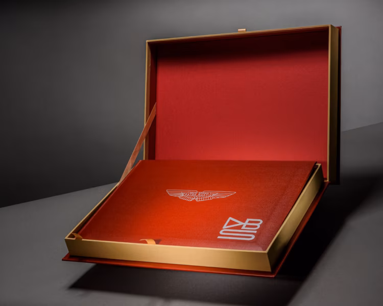 An automotive presentation book with an Aston Martin cover mark