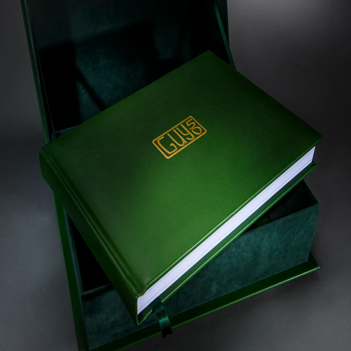 Deep green personalised photo book in a matching presentation box