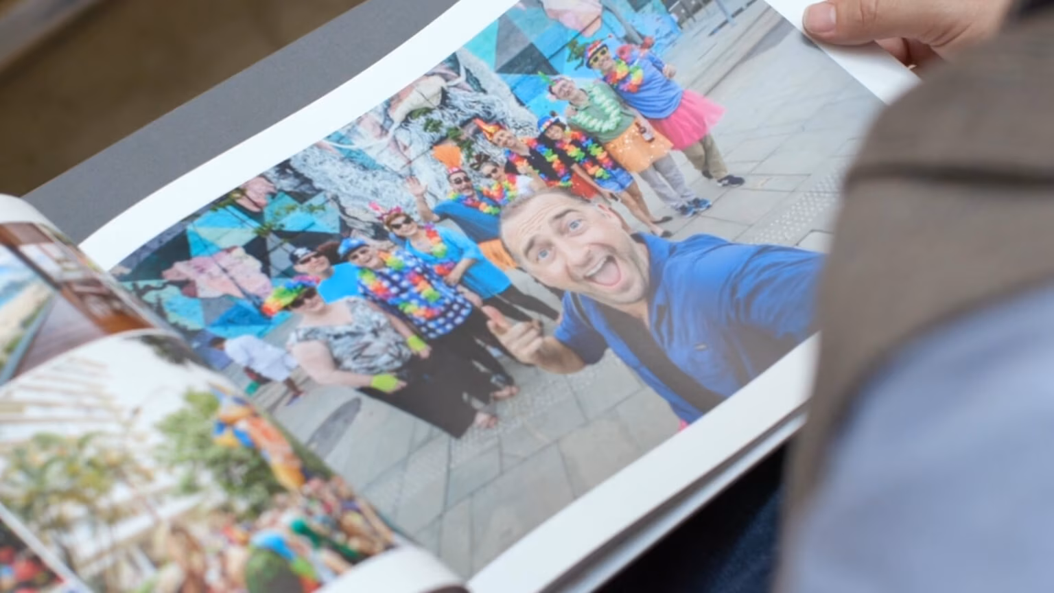 An open photo book showing a group photograph from a journey