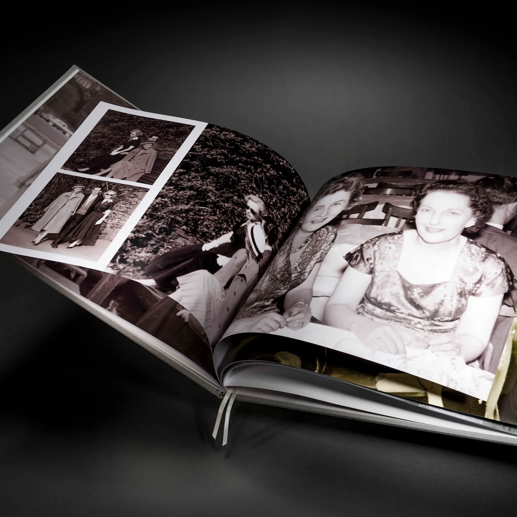 A family history book open across restored archive photographs