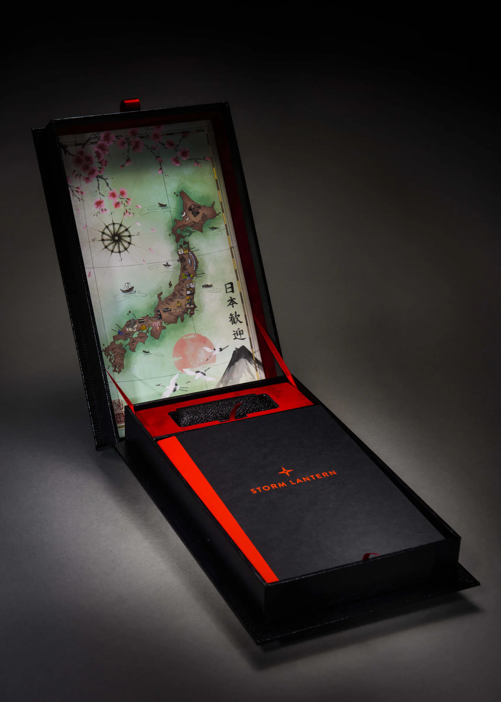 Japanese travel presentation book and map-lined box with red ribbon details