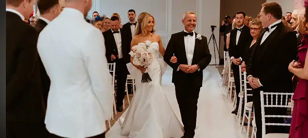 Bride walking down the wedding ceremony aisle with her father