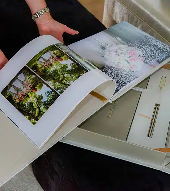 A bespoke wedding book opened to a photographic spread