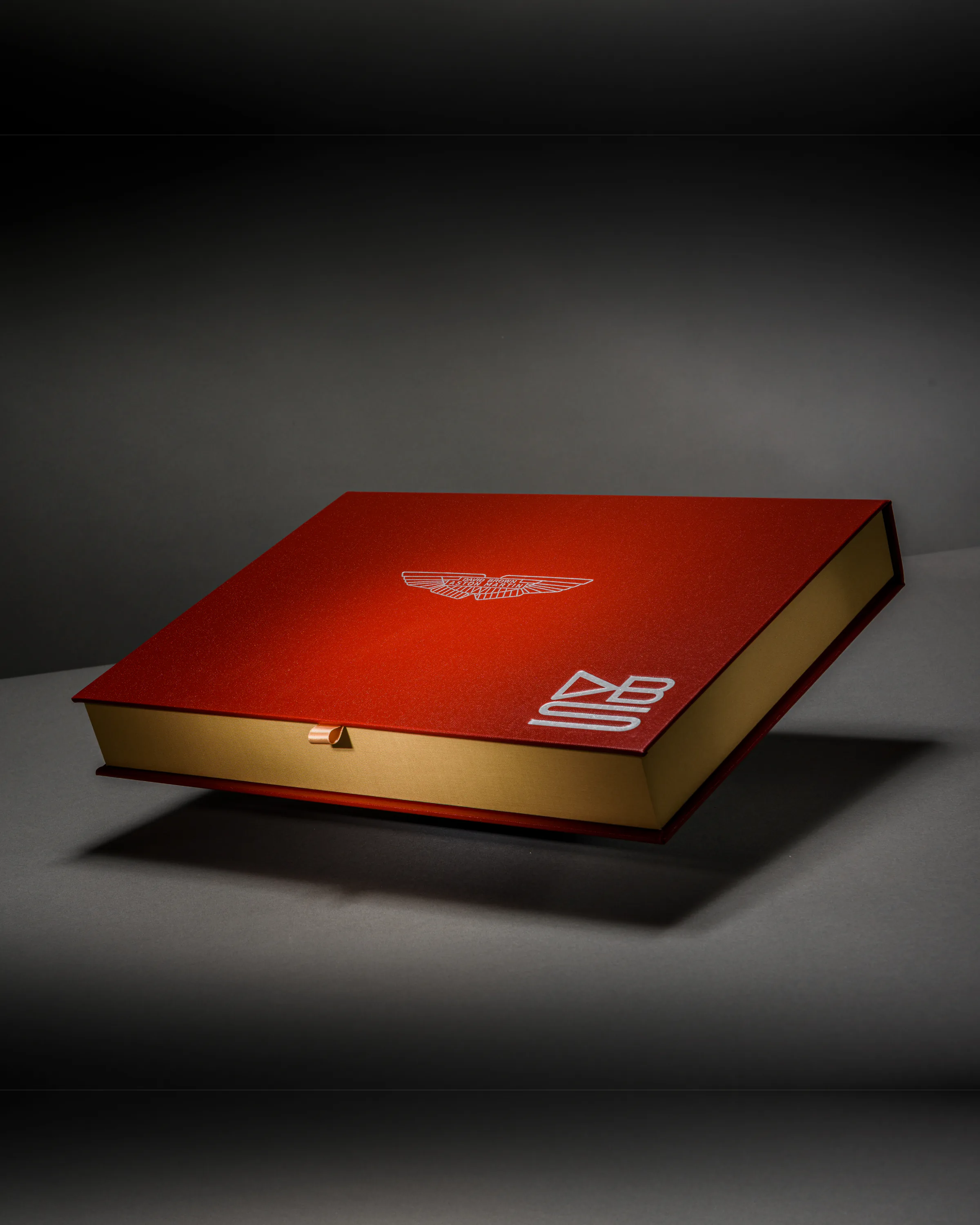 Red Aston Martin limited-edition book finished with silver and gold marque details