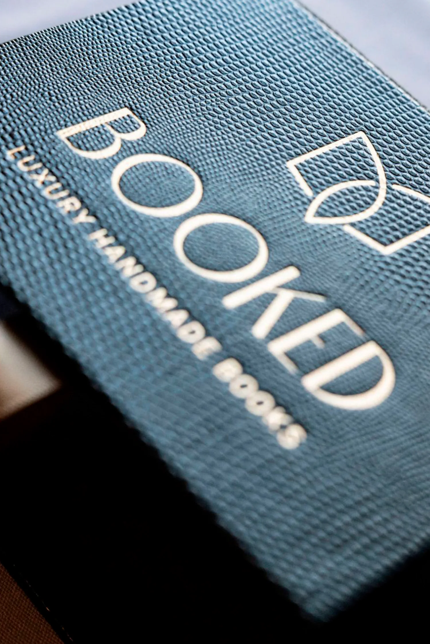 Blue textured book cloth embossed with the Booked Images name