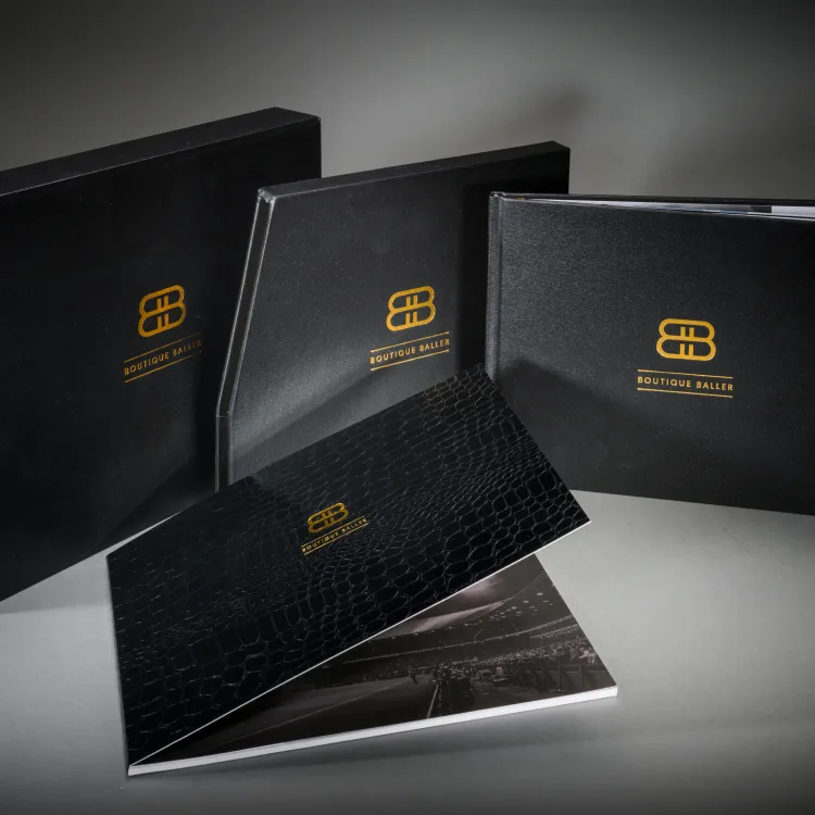 Boutique Baller branded black books and presentation pieces with gold foil details
