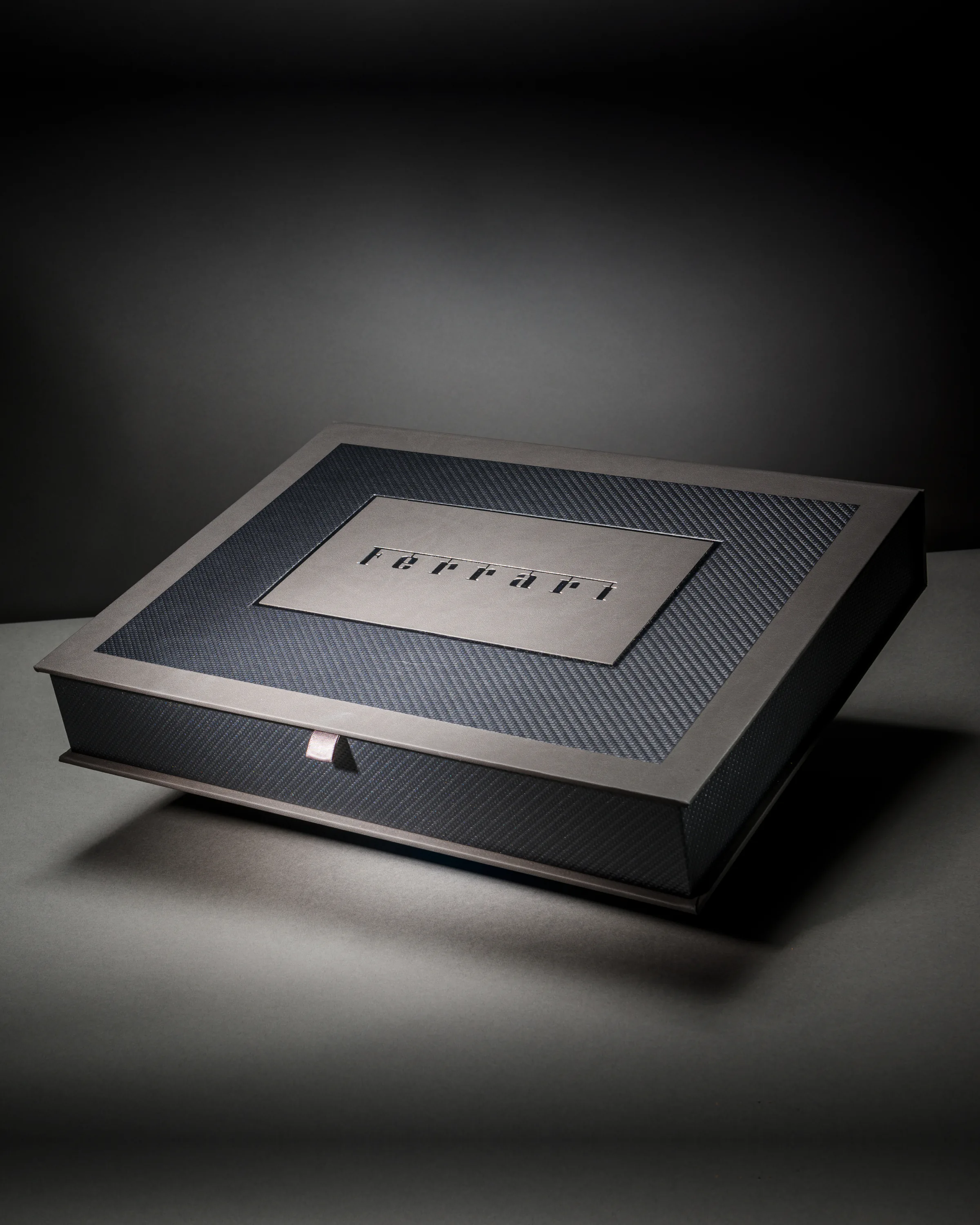 Ferrari presentation box with a carbon-fibre finish and inset marque panel