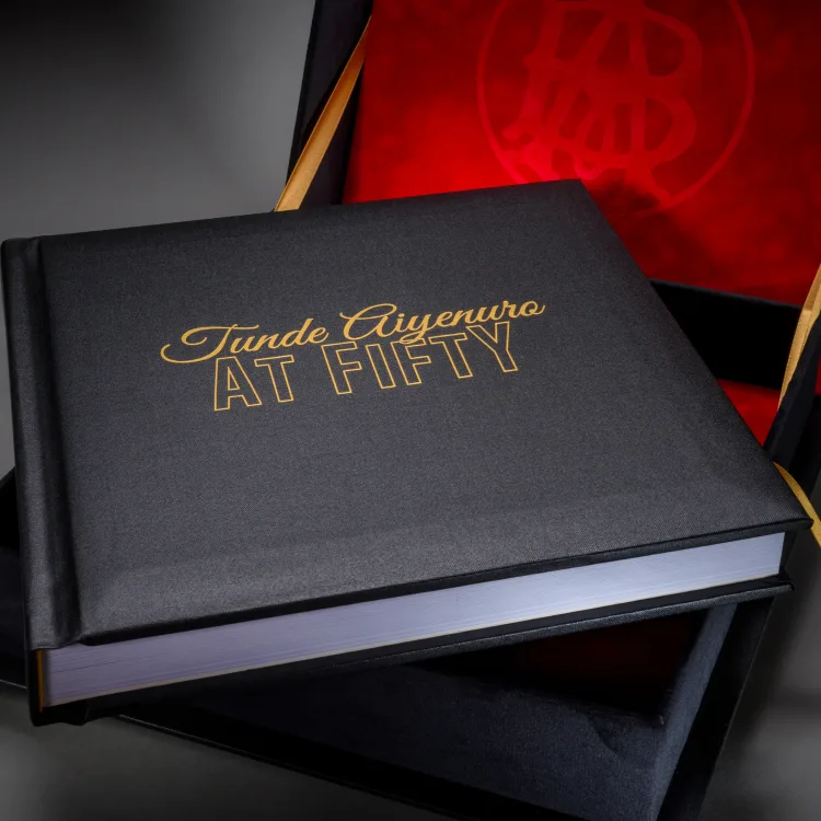 Black fiftieth birthday celebration book in a red-lined presentation box