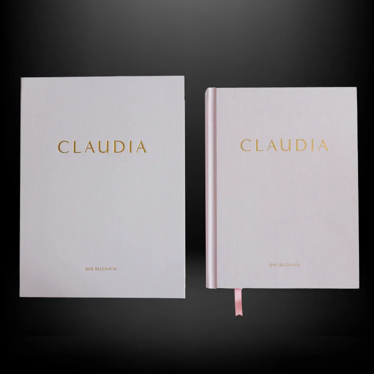 Pale pink Claudia celebration book beside a personalised keepsake wallet