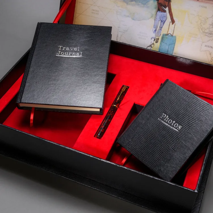 Travel journal and photographs book arranged in a red-lined bespoke gift box
