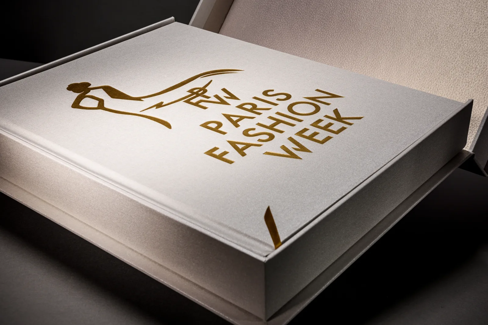 White Paris Fashion Week photo book and presentation box with gold detailing