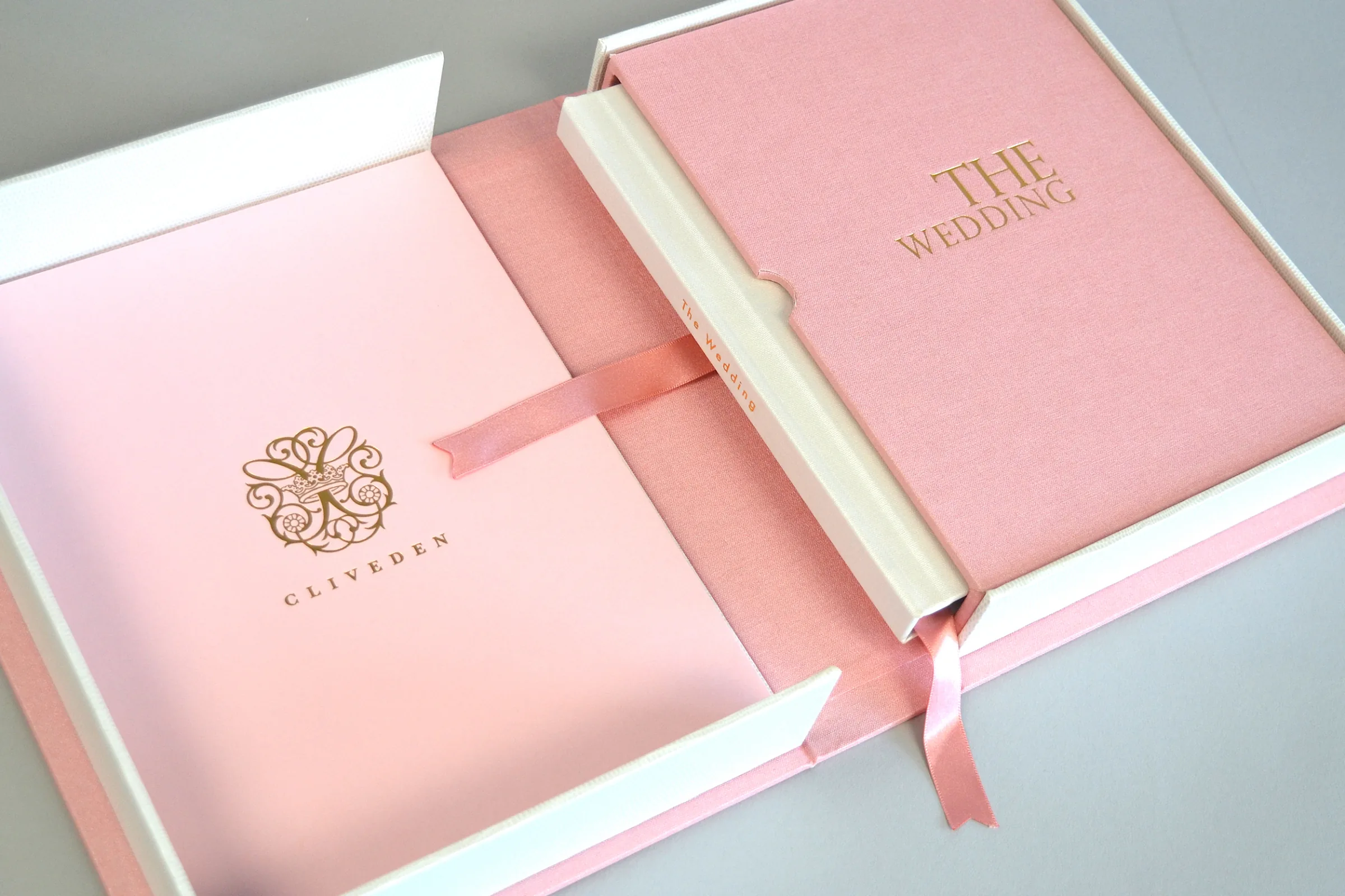 Pink wedding photo book resting inside a matching presentation box