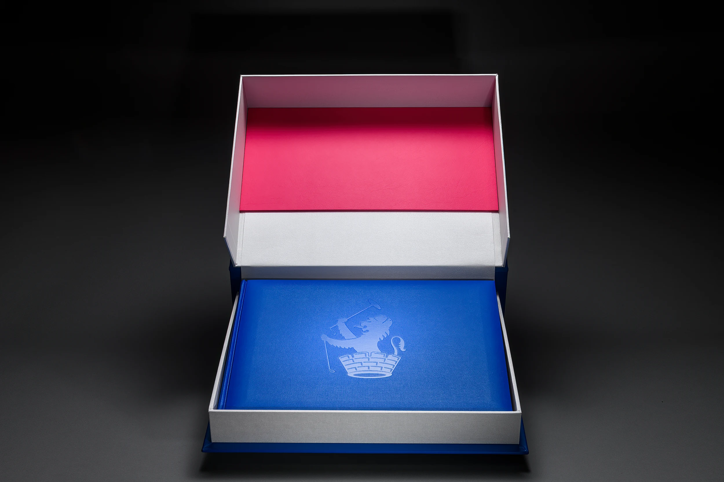 Open red and blue clamshell presentation case for a bespoke book