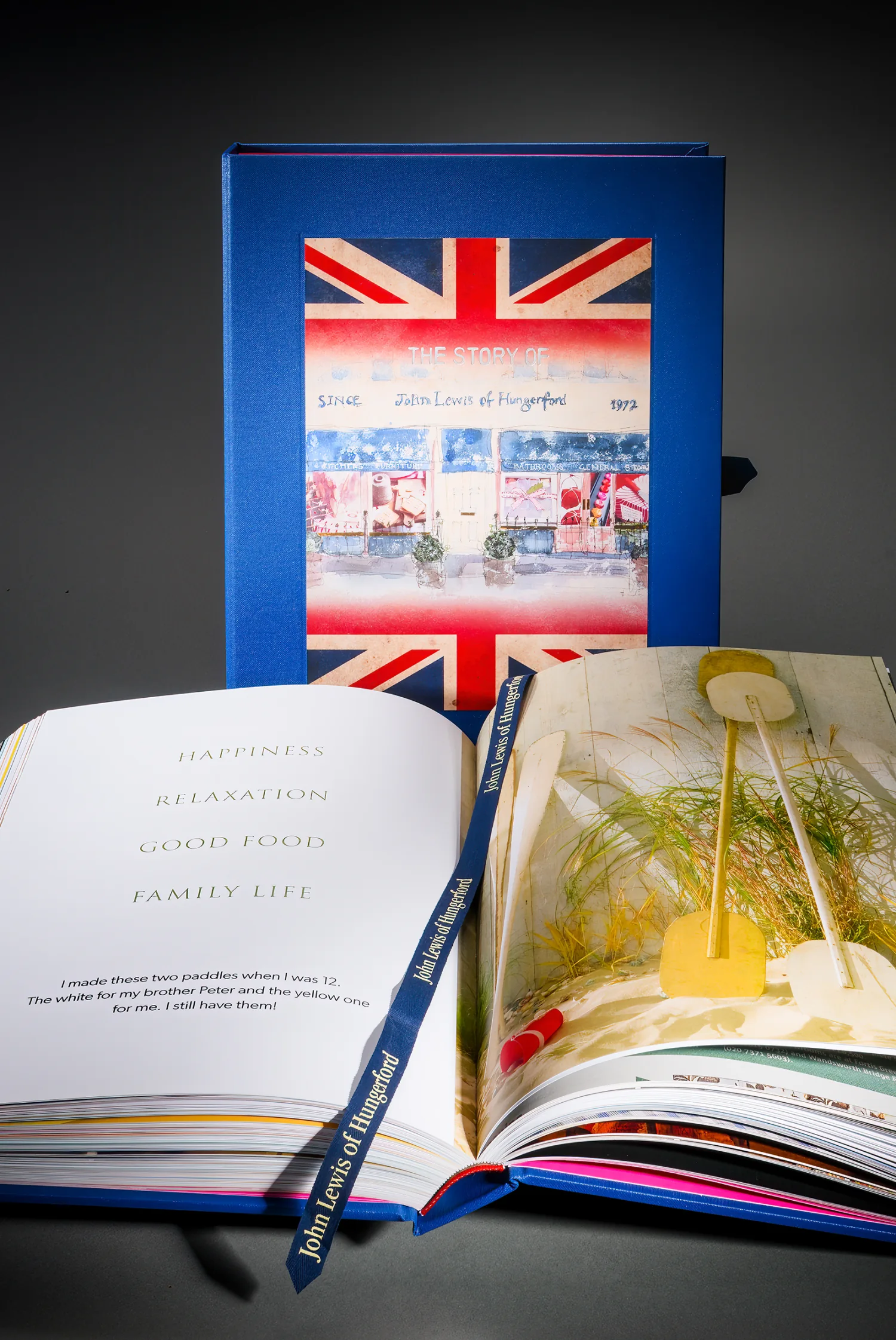 John Lewis of Hungerford heritage book open beside its blue Union Jack presentation case